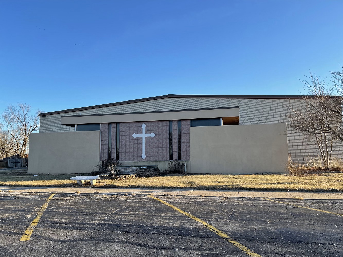 Brick church with large white cross on front